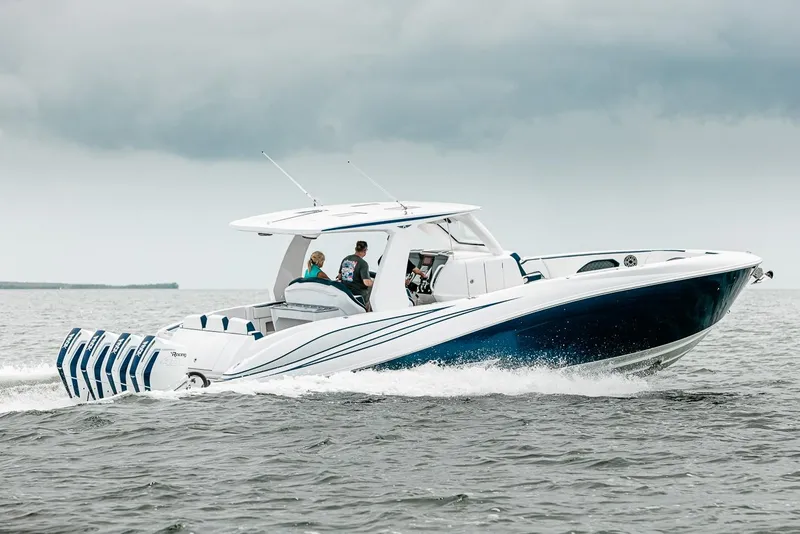Slide: The Image of Manufacturer Provided Image: 2025 Deep Impact 399 Sport boat cruising on open water under cloudy skies. - 6