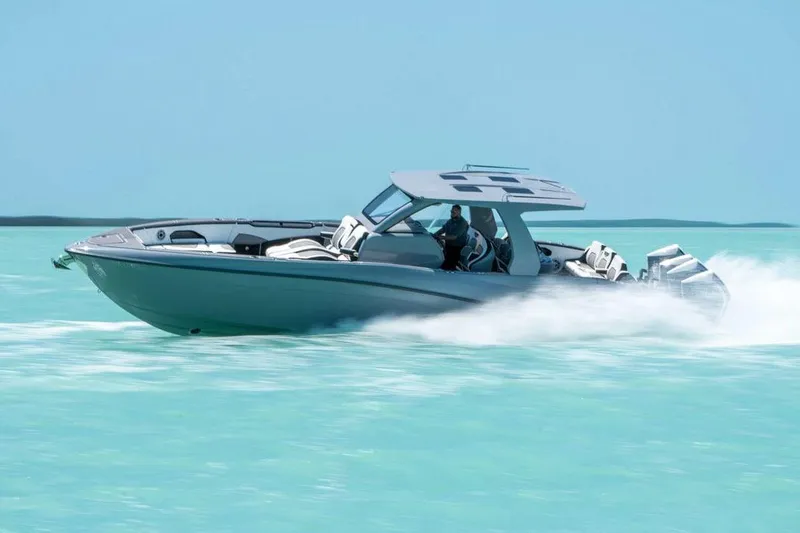 Slide: The Image of Manufacturer Provided Image: 2026 Deep Impact 399 Sport boat speeding on turquoise water. - 3
