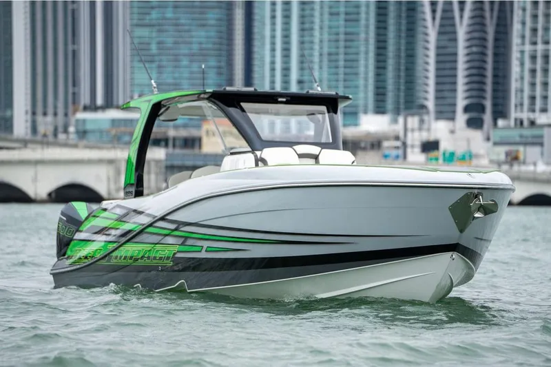 Slide: The Image of Manufacturer Provided Image: 2026 Deep Impact 399 Sport boat on water with city skyline background. - 2