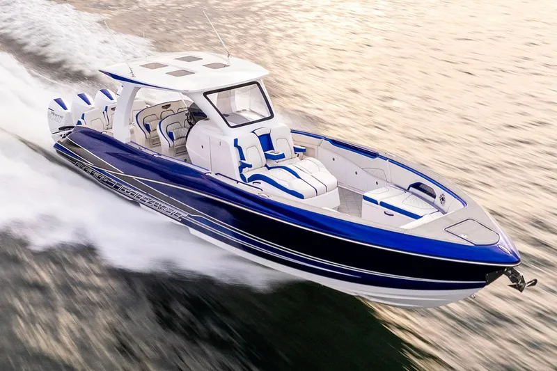 Slide: The Image of Manufacturer Provided Image: 2025 Deep Impact 399 Sport boat cruising on water, featuring sleek blue and white design. - 4