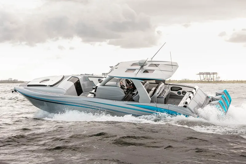 Slide: The Image of Manufacturer Provided Image: 2025 Deep Impact 399 Cabin boat cruising on choppy waters under cloudy skies. - 3