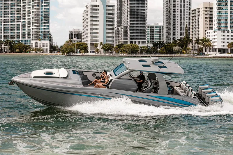 Slide: The Image of Manufacturer Provided Image: 2025 Deep Impact 399 Cabin boat cruising near city skyline. - 2