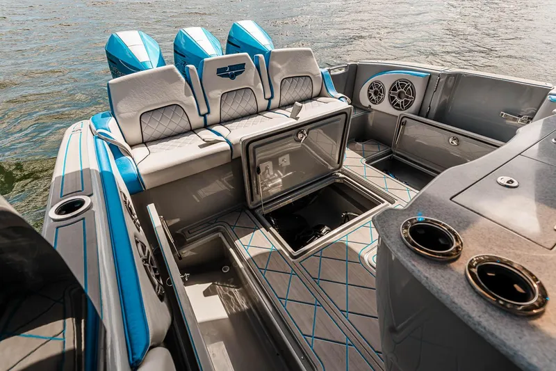 Slide: The Image of Manufacturer Provided Image: 2025 Deep Impact 369 Sport boat interior with open storage compartments and blue seating. - 8