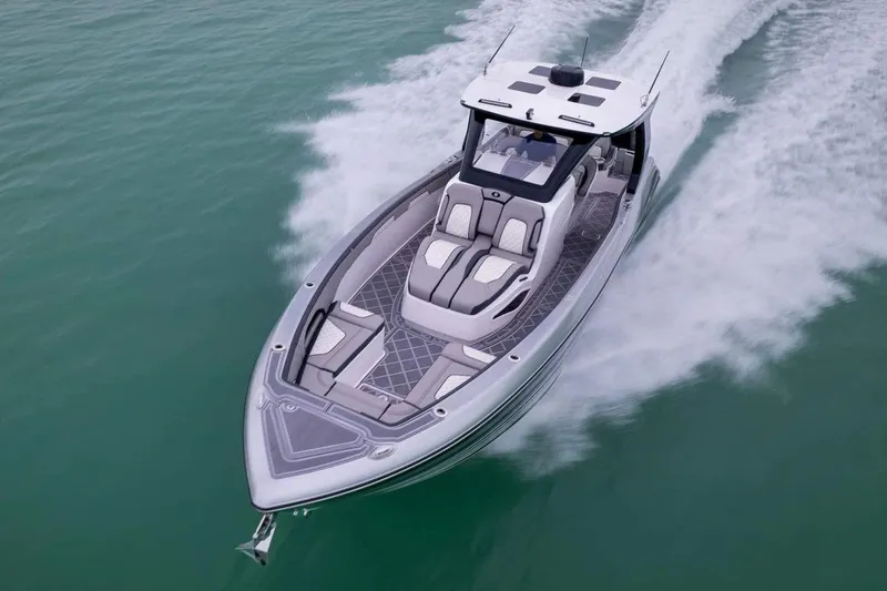 Slide: The Image of Manufacturer Provided Image: 2026 Deep Impact 369 Sport boat cruising on turquoise water, showcasing sleek design and luxury. - 1