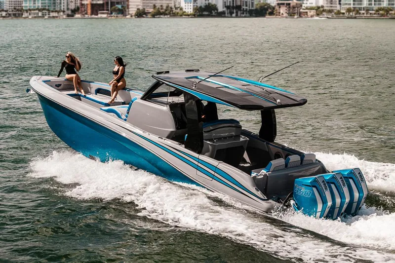 Slide: The Image of Manufacturer Provided Image: 2025 Deep Impact 369 Sport boat cruising on water with two passengers. - 4