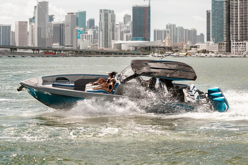 Slide: The Image of Manufacturer Provided Image: 2025 Deep Impact 369 Sport boat cruising near city skyline. - 3