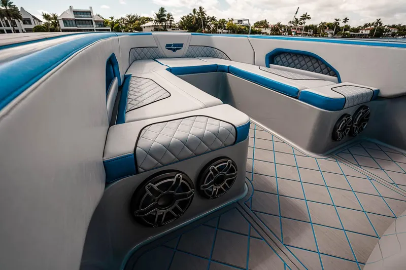 Slide: The Image of Manufacturer Provided Image: Luxurious interior of 2025 Deep Impact 369 Sport boat with blue and gray seating. - 6