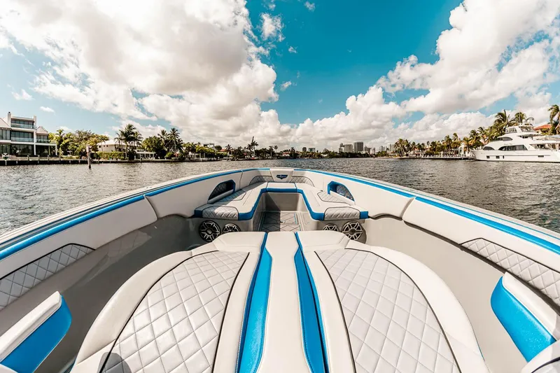 Slide: The Image of Manufacturer Provided Image: 2025 Deep Impact 369 Sport boat interior with blue and gray seating on a sunny day. - 5