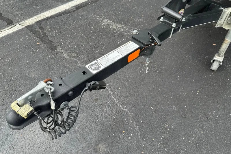 Slide: The Image of Trailer hitch of a 2021 Tracker Pro Team 170 TX on asphalt surface. - 22