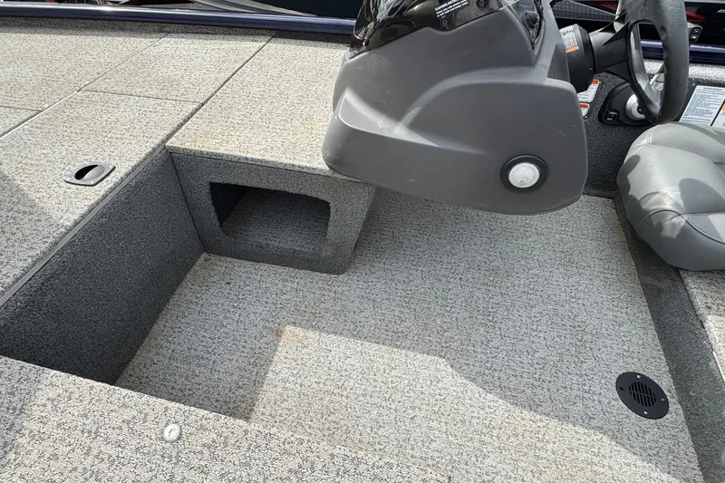 Slide: The Image of 2021 Tracker Pro Team 170 TX boat interior with carpeted deck and steering console. - 14