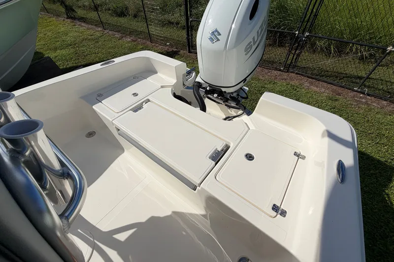 Slide: The Image of 2027 Pioneer 220 Bay Sport boat with Suzuki outboard motor, featuring spacious deck layout. - 17