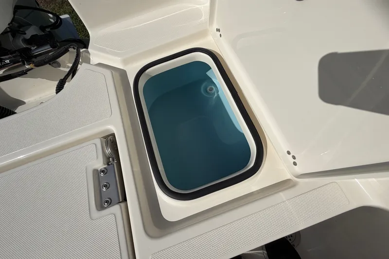 Slide: The Image of Livewell compartment on a 2027 Pioneer 220 Bay Sport boat, showcasing interior design. - 18
