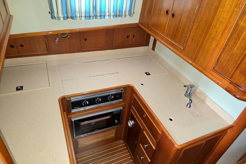 Slide: The Image of Galley kitchen in 2001 Grand Banks 43 Eastbay HX yacht with wood cabinetry and modern appliances. - 19
