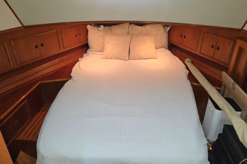 Slide: The Image of Cozy cabin bedroom in 2001 Grand Banks 43 Eastbay HX yacht with wooden cabinetry. - 20