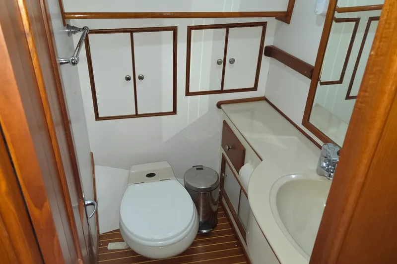 Slide: The Image of Bathroom interior of 2001 Grand Banks 43 Eastbay HX yacht, featuring wood accents and modern fixtures. - 25