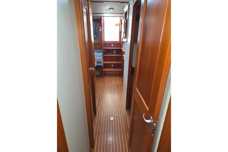 Slide: The Image of Interior hallway of 2001 Grand Banks 43 Eastbay HX yacht with wooden flooring and cabinetry. - 22