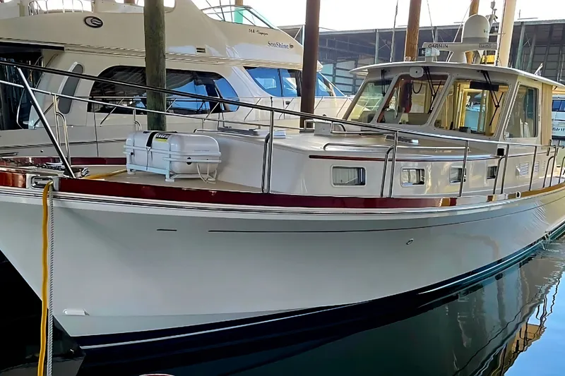 Slide: The Image of 2001 Grand Banks 43 Eastbay HX yacht docked in a marina, showcasing elegant design. - 3