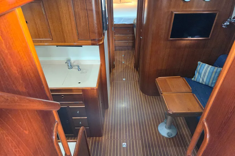 Slide: The Image of Interior of 2001 Grand Banks 43 Eastbay HX yacht with wood finish and compact seating area. - 16