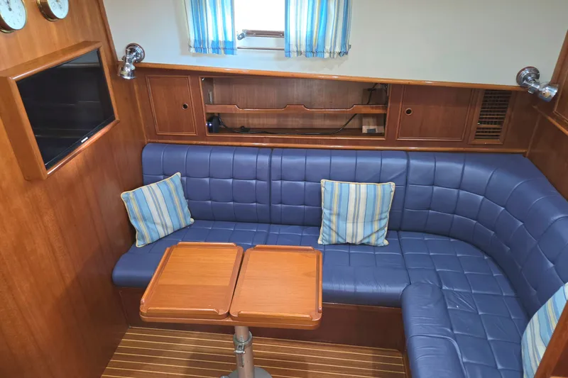 Slide: The Image of Luxurious 2001 Grand Banks 43 Eastbay HX yacht interior with blue leather seating and wooden accents. - 17