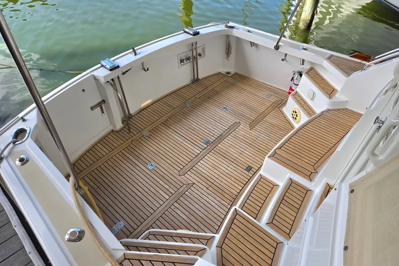 Slide: The Image of 2001 Grand Banks 43 Eastbay HX yacht deck with teak flooring and seating. - 8