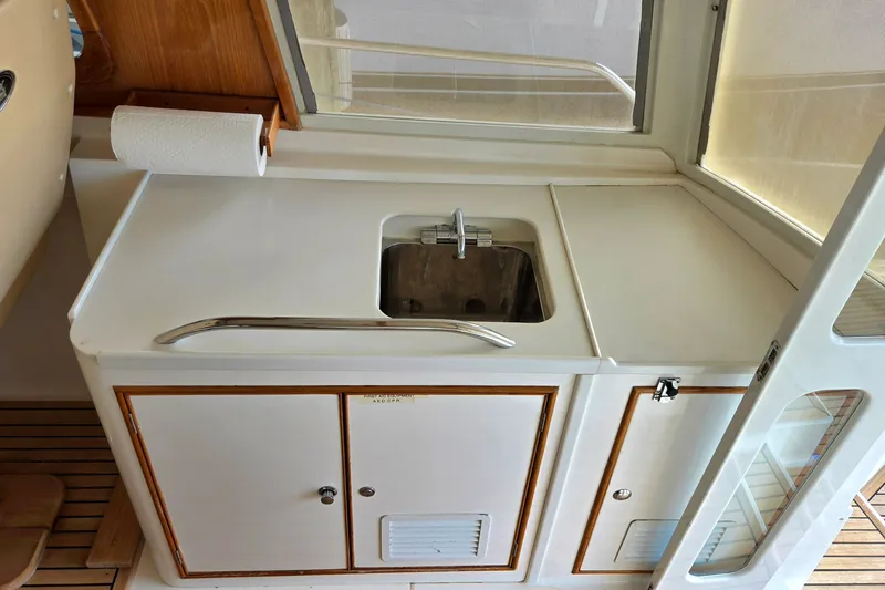 Slide: The Image of Compact galley area on 2001 Grand Banks 43 Eastbay HX yacht with sink and storage. - 15