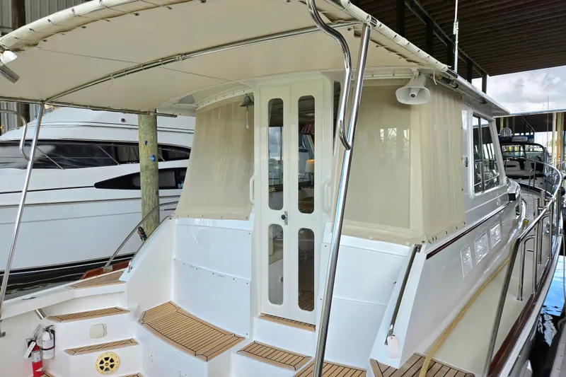 Slide: The Image of 2001 Grand Banks 43 Eastbay HX yacht with covered deck and elegant design in marina. - 9