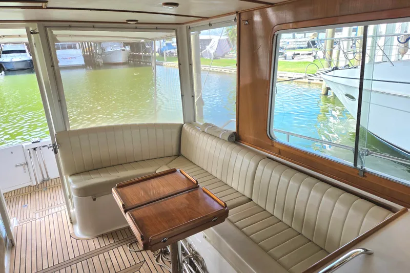 Slide: The Image of Interior of 2001 Grand Banks 43 Eastbay HX with elegant seating and wooden table. - 14