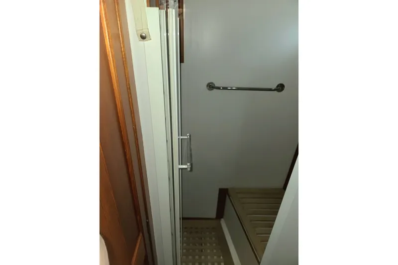 Slide: The Image of Interior of 2001 Grand Banks 43 Eastbay HX yacht, featuring a compact shower area. - 26