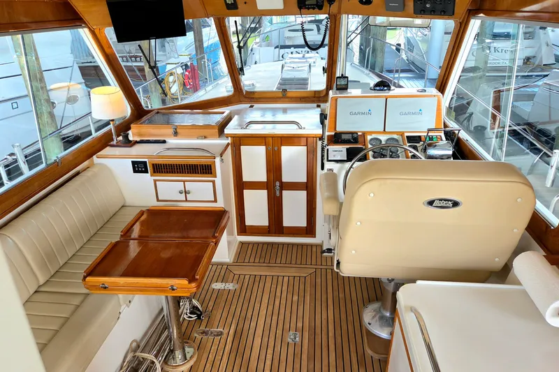 Slide: The Image of Luxurious 2001 Grand Banks 43 Eastbay HX yacht interior with helm, seating, and navigation equipment. - 10