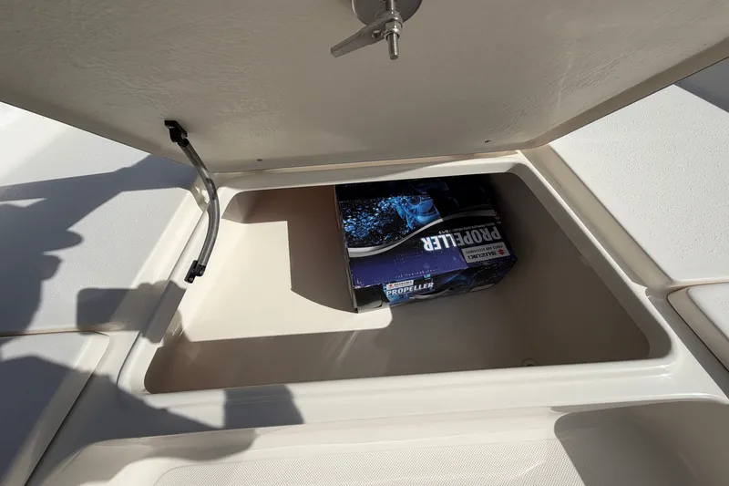 Slide: The Image of Open storage compartment on 2027 Bulls Bay 2200 XS boat with propeller box inside. - 10