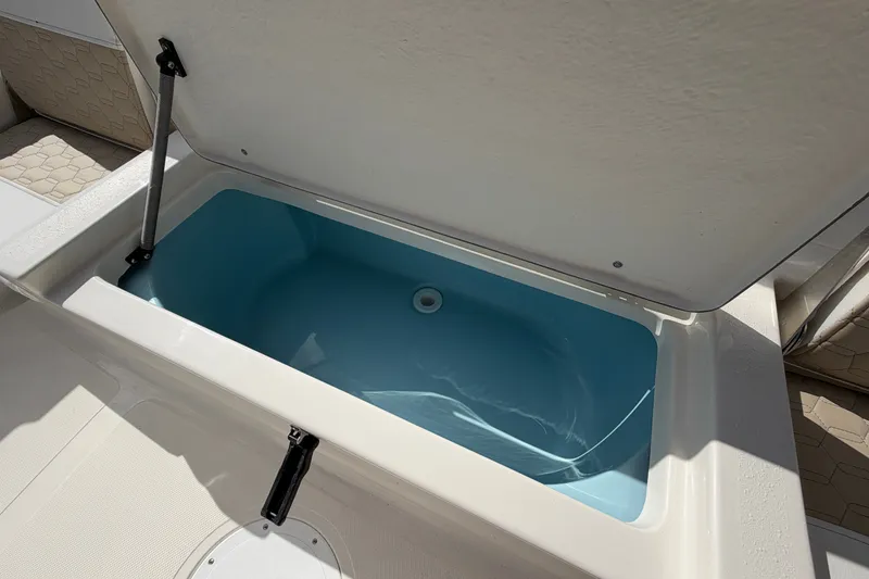 Slide: The Image of Livewell compartment on a 2027 Bulls Bay 2200 XS boat, open lid view. - 17