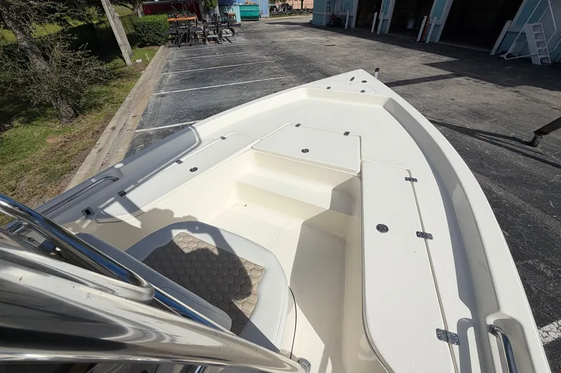Slide: The Image of 2027 Bulls Bay 2200 XS boat interior, showcasing spacious deck and seating area. - 9