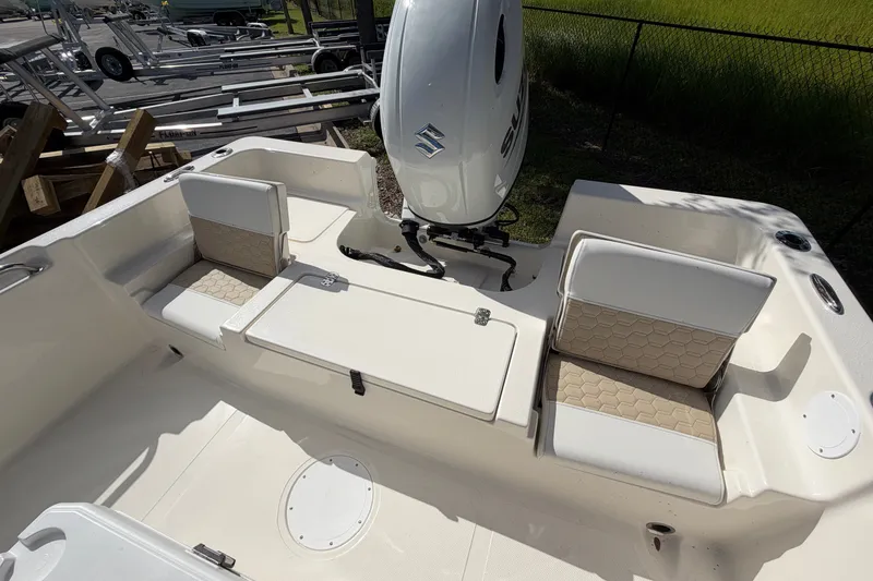 Slide: The Image of 2027 Bulls Bay 2200 XS boat interior with seating and Suzuki outboard motor. - 16
