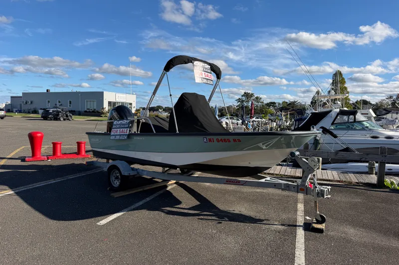 Slide: The Image of 2017 Boston Whaler 170 Montauk boat for sale on trailer in marina parking lot. - 18