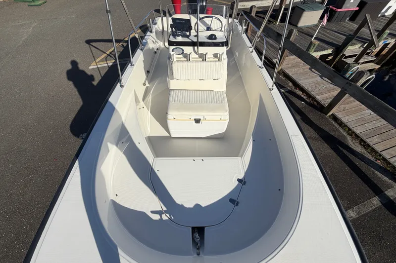 Slide: The Image of 2017 Boston Whaler 170 Montauk boat, top view, docked, showcasing seating and console. - 15