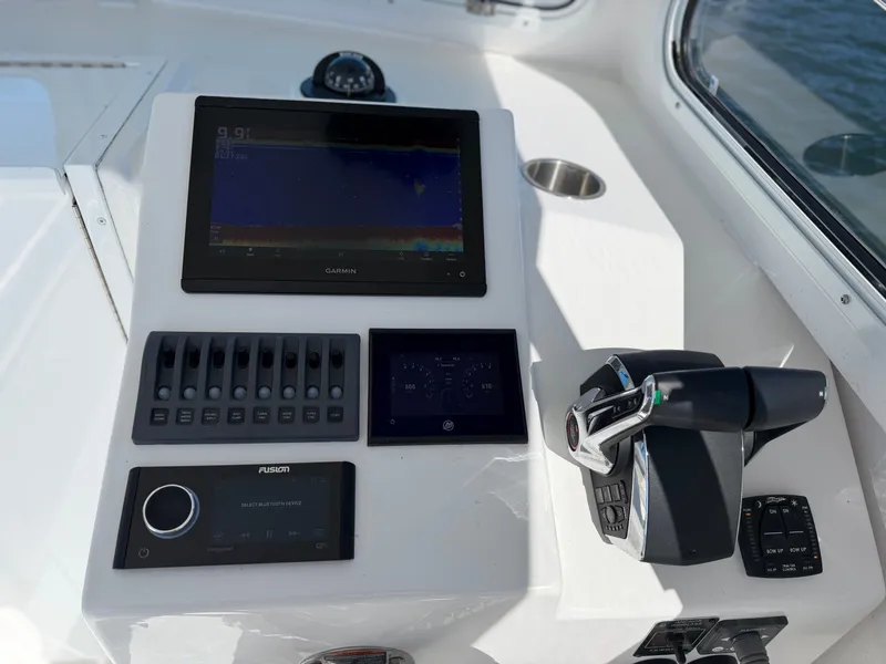 Slide: The Image of The image shows the helm of a 2024 Steiger Craft 255 Miami boat with modern navigation equipment. - 15