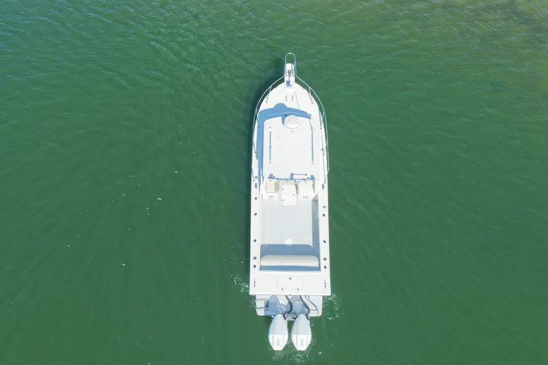 Slide: The Image of Aerial view of a white Steiger Craft 255 Miami boat on calm water. - 23