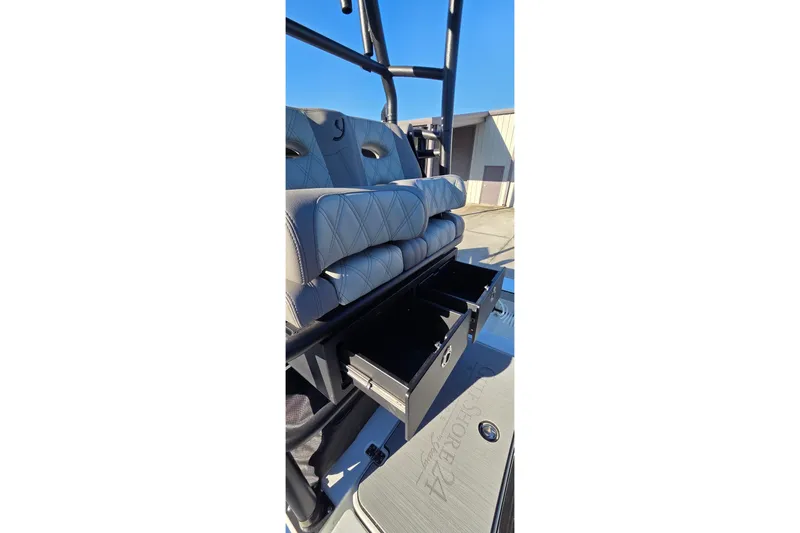Slide: The Image of 2024 Young Boats 26 Gulfshore seating with storage drawers open, showcasing luxury design. - 28