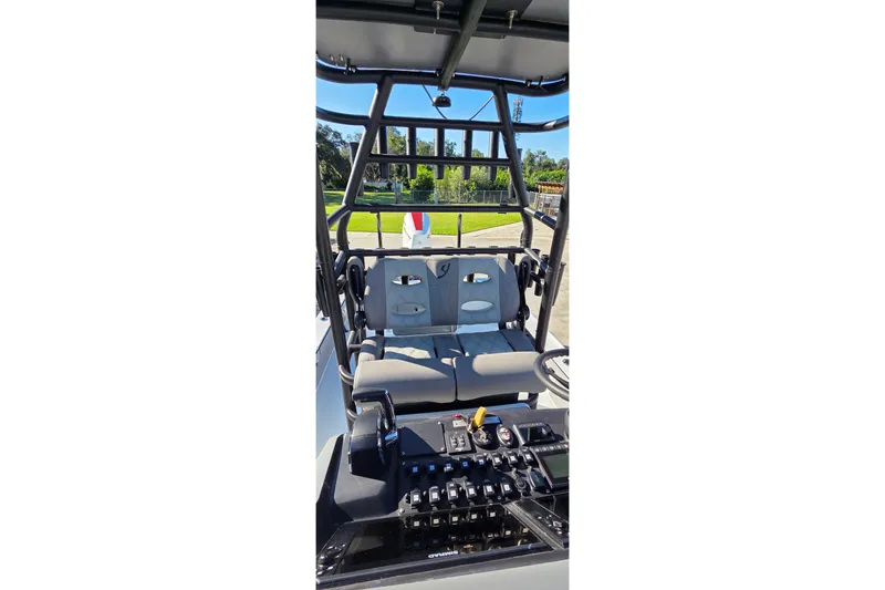 Slide: The Image of 2024 Young Boats 26 Gulfshore interior with seating and control panel. - 26