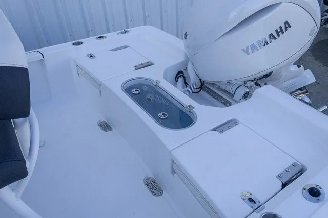 Slide: The Image of The image shows the stern of a Tidewater 2110 Bay Max with a Yamaha outboard motor. - 10