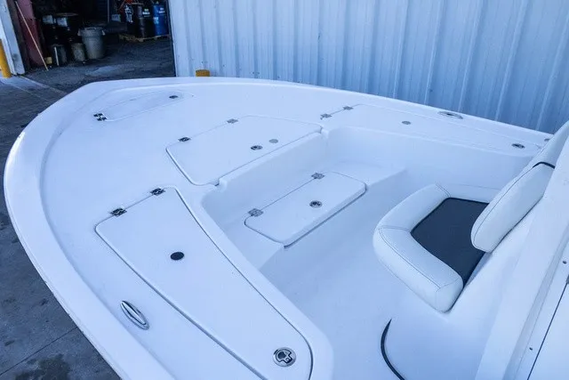 Slide: The Image of The image shows the bow deck of a Tidewater 2110 Bay Max boat with white seating. - 1