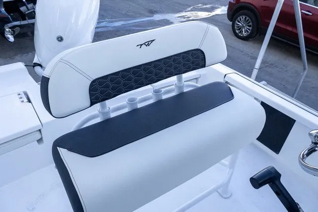 Slide: The Image of The image shows a white and black boat seat with an embroidered logo on the backrest. - 8