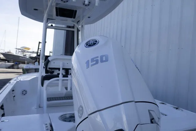 Slide: The Image of The image shows a white boat with a 150 HP outboard motor. - 13