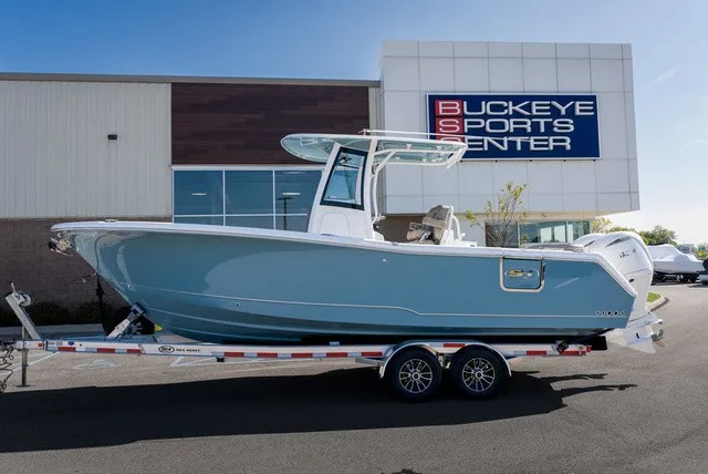 Slide: The Image of 2027 Sea Hunt Ultra 265SE in front of a sports center. - 3