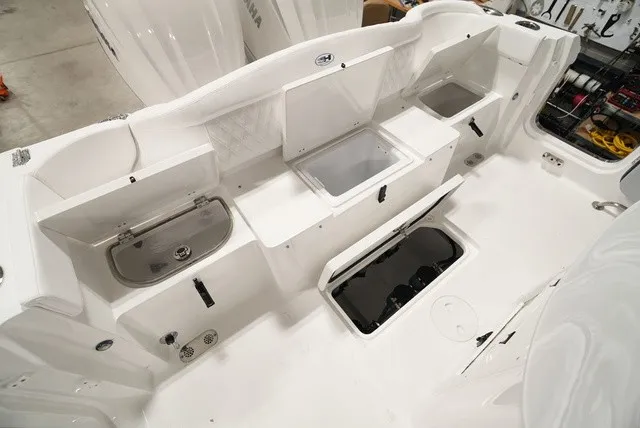 Slide: The Image of The image shows the cockpit of a Sea Hunt Ultra 285SE boat with multiple storage compartments. - 6
