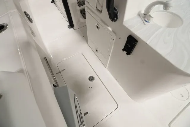 Slide: The Image of The image shows the deck of a Sea Hunt Ultra 285SE boat with storage and fixtures. - 10