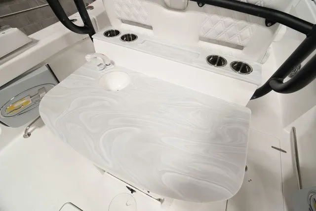 Slide: The Image of A sleek white boat table with an integrated sink and cup holders on a Sea Hunt Ultra 285SE. - 9