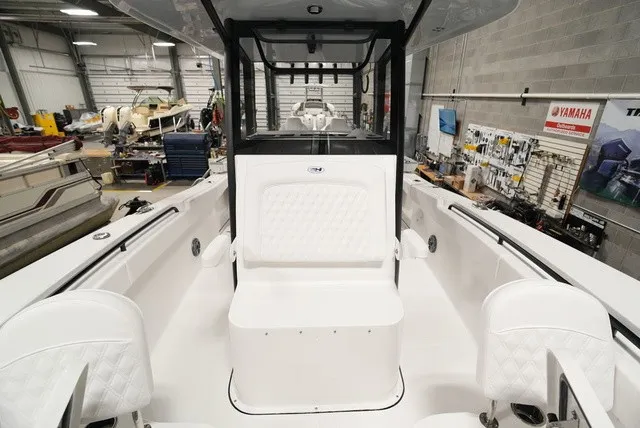 Slide: The Image of The image shows the cockpit of a 2027 Sea Hunt Ultra 285SE boat in a workshop. - 18