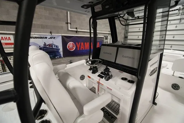 Slide: The Image of The image shows the cockpit of a Sea Hunt Ultra 285SE boat with dual Garmin screens. - 11