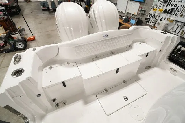 Slide: The Image of The image shows the stern of a Sea Hunt Ultra 285SE boat with twin engines and a white bench seat. - 5
